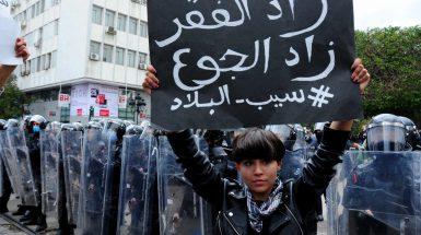 "Poverty grows, deprivation grows". A protestor surrounded by the police, on January 23rd, in Tunis.