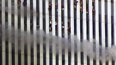 People look out of the burning North Tower of the World Trade Center, September 11, 2001. REUTERS/Jeff Christensen